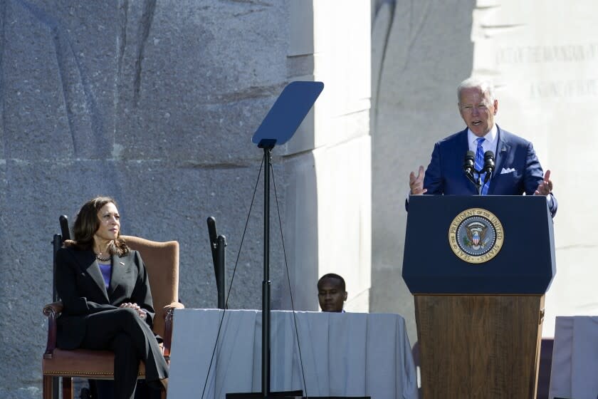 Vice President Kamala Harris listens as President Joe Biden speaks during an event marking the 10th anniversary of the dedication of the Martin Luther King, Jr. Memorial in Washington, Thursday, Oct. 21, 2021. (AP Photo/Susan Walsh)