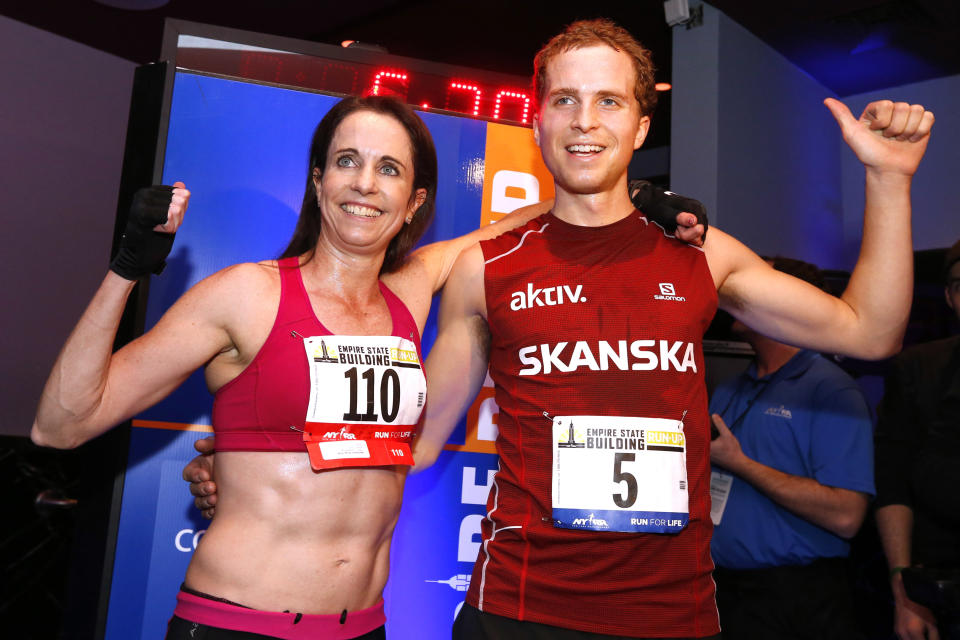 Women's and men's division champions Suzy Walsham and Thorbjorn Ludvigsen pose together after the Empire State Building Run-Up, Wednesday, Feb. 5, 2014, in New York. (AP Photo/Jason DeCrow)