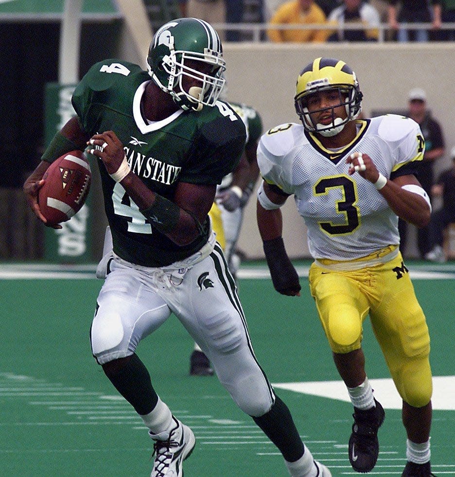 MSU's Plaxico Burress eludes Michigan defender Todd Howard, right, on a 68-yard pass play  in 1999. Burress caught 10 passes in the Spartans' win.
