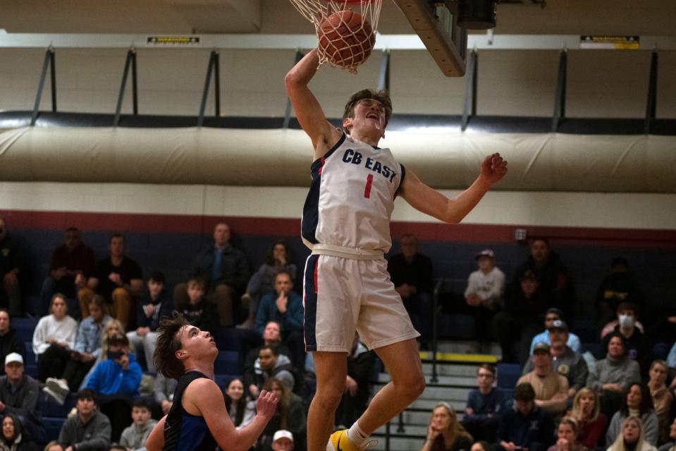 CB East sophomore Jacob Cummiskey jumps for a rebound as the ball makes it through the hoop at Central Bucks High School East on Friday, Feb. 4, 2022. The Patriots defeated the Titans 70-52. 