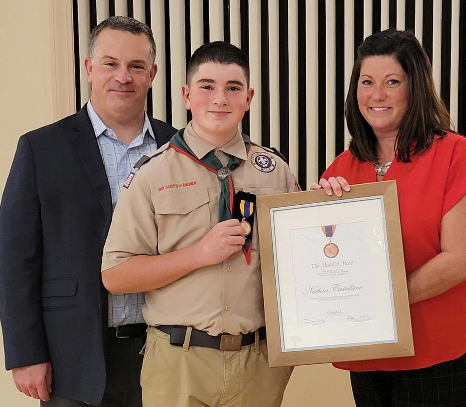 Nathan Castellano, a 12-year-old Scout from Auburn, receives Certificate of Merit for saving a child from drowning. Shown with Nathan are his parents Brian and Amy Castellano. 