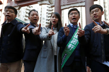 (L-R) Pro-democracy activist Joshua Wong, lawmaker and Democratic Party Chairman Wu Chi-wai, activist Agnes Chow, Legislative Council by-election candidate Au Nok-hin and disqualified lawmaker Nathan Law campaign on the by-election day in Hong Kong, China March 11, 2018. REUTERS/Bobby Yip