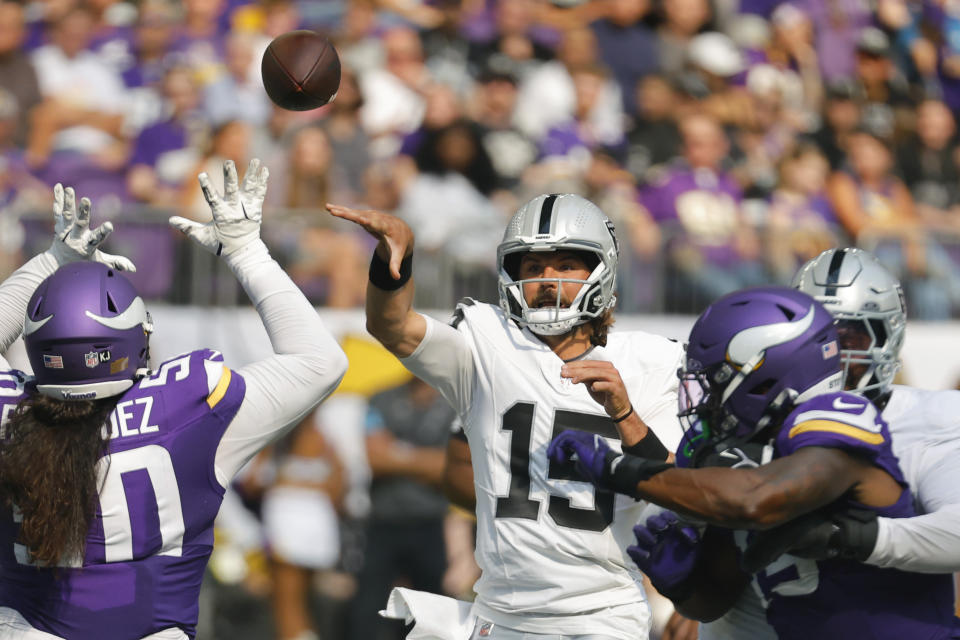 Las Vegas Raiders quarterback Gardner Minshew II (15) throws against the Minnesota Vikings during the first half of an NFL football game Saturday, Aug. 10, 2024, in Minneapolis. (AP Photo/Bruce Kluckhohn)