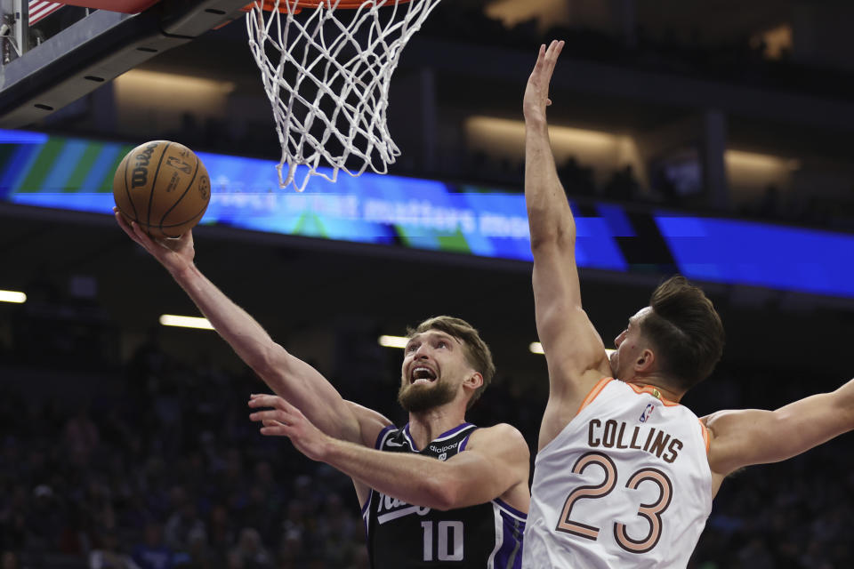 Sacramento Kings forward Domantas Sabonis (10) shoots against San Antonio Spurs forward Zach Collins (23) during the first half of an NBA basketball game in Sacramento, Calif, Thursday, March 7, 2024. (AP Photo/Jed Jacobsohn)