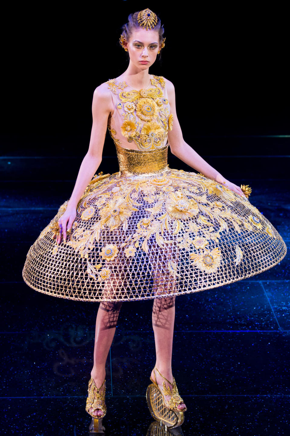 <p>Model wears a yellow-floral embellished dress with a wide cage skirt from the Guo Pei SS18 Haute Couture show. (Photo: Getty Images) </p>