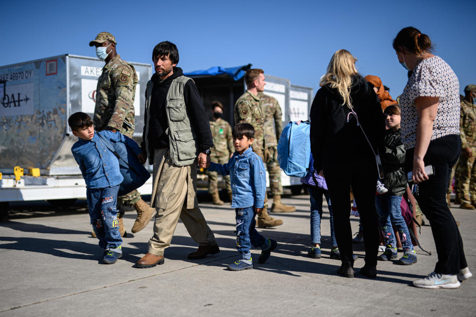 Evacuees from Afghanistan drop off their luggage to board a passenger plane bound for the U.S. at the U.S. military's Ramstein air base on October 09, 2021 in Ramstein, Germany. / Credit: Lukas Schulze / Getty Images