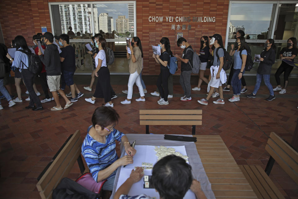 Pro-democracy university students march against police brutality at the University of Hong Kong, Wednesday, Nov. 6, 2019. The protests began in early June against a now-abandoned extradition bill that would have allowed suspects to be sent for trials in mainland China, which many saw as infringing of Hong Kong's judicial freedoms and other rights that were guaranteed when the former British colony returned to China in 1997. The movement has since grown into calls for greater democracy and police accountability. (AP Photo/Kin Cheung)