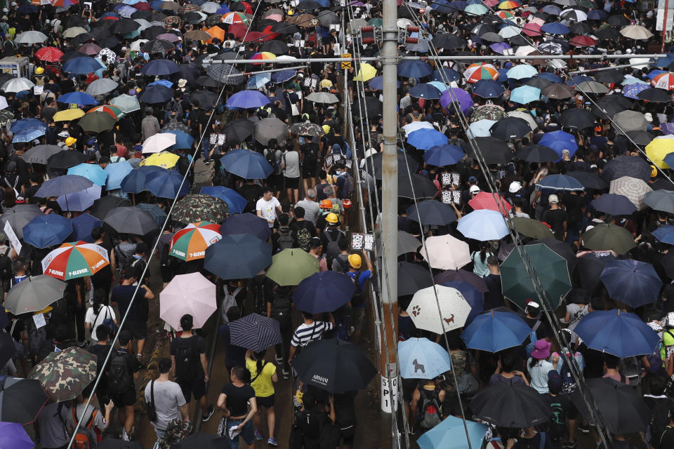 Protesters rally at Yuen Long in Hong Kong Saturday, July 27, 2019. Thousands of protesters began marching Saturday despite police warnings that their presence would spark confrontations with local residents. Demonstrators wearing black streamed through Yuen Long, the area where a mob brutally attacked people in a commuter rail station last Sunday. (AP Photo/Vincent Yu)