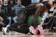 Toronto Raptors' Pascal Siakam, left, wrestles Boston Celtics' Derrick White for a loose ball during the first half of an NBA basketball game in Toronto, Monday, Dec. 5, 2022. (Chris Young/The Canadian Press via AP)
