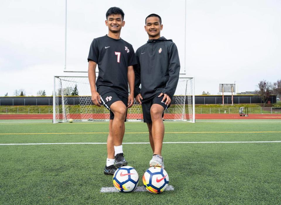 Franklin Pierce High School sophomore twin brothers Preston Soeum, left, and Marvin Soeum pose for a portrait on the soccer field at Franklin Pierce High School in Tacoma, Wash. on Monday, April 11, 2022. The brothers have the Cardinals sitting in first place in the 2A SPSL.