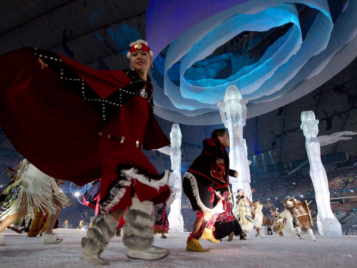 Indigenous dancers perform at the Vancouver 2010 Olympics opening ceremony. While Indigenous groups were significantly involved in those Games, four prominent First Nations are now leading a bid to bring the Olympics and Paralympics to B.C. in 2030. (Darryl Dyck/The Canadian Press - image credit)