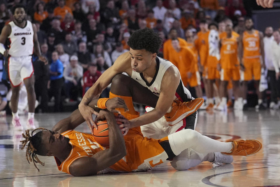 Tennessee guard Jahmai Mashack (15) and Georgia guard Jabri Abdur-Rahim (1) scramble for a loose ball during the second half of an NCAA college basketball game Saturday, Jan. 13, 2024, in Athens, Ga. (AP Photo/John Bazemore)