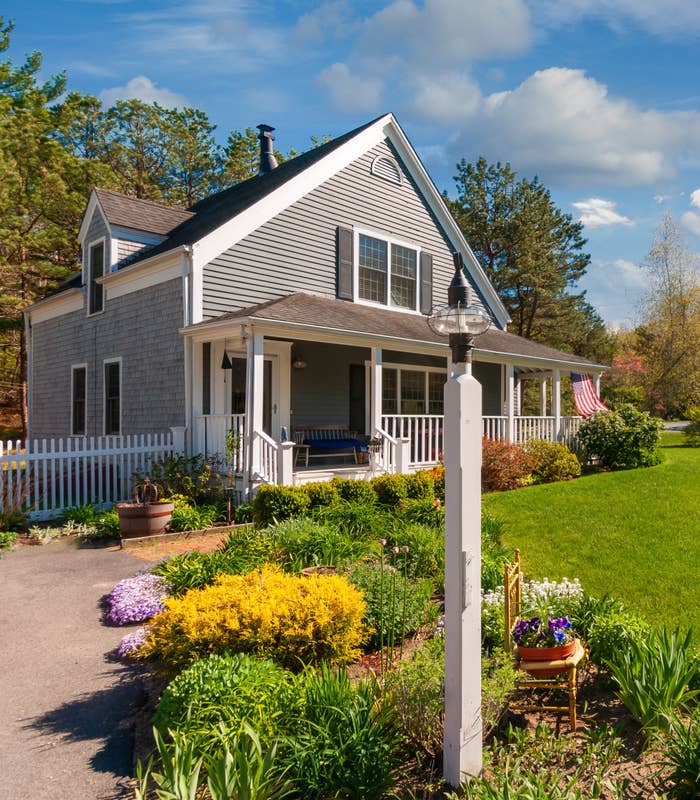 The exterior and front yard of a house with a porch