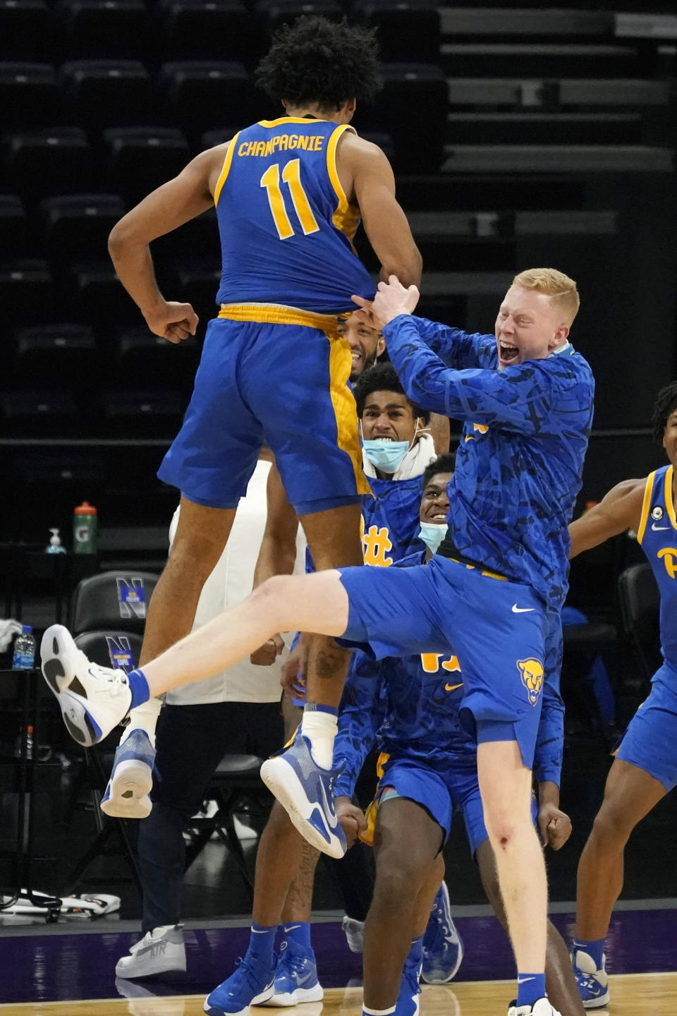 Pittsburgh's Justin Champagnie (11) celebrates with teammates after Pittsburgh defeated Northwestern in an NCAA college basketball game in Evanston, Ill., Wednesday, Dec. 9, 2020. (AP Photo/Nam Y. Huh)