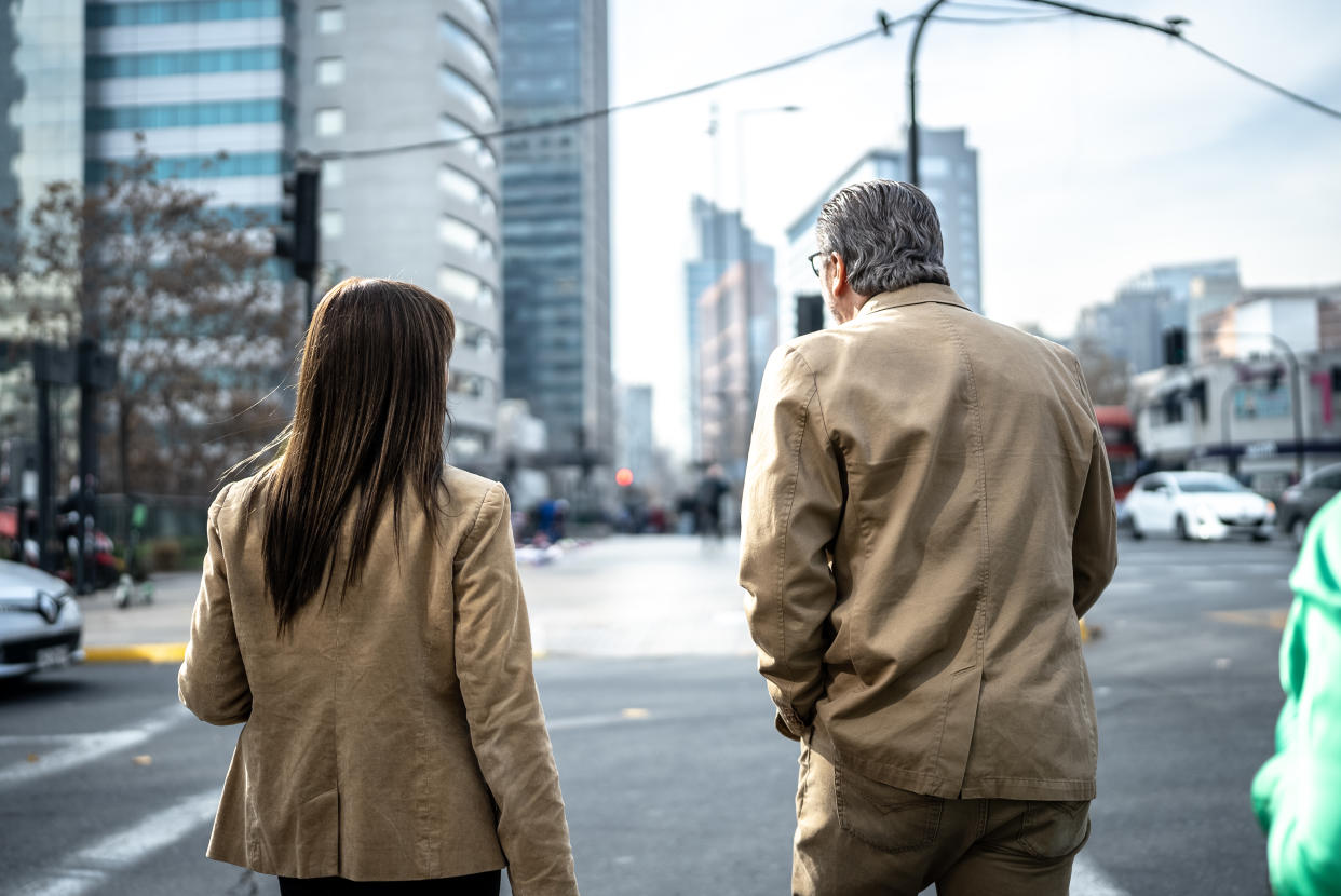 Coworkers walking and talking outdoors