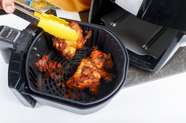 <p>i'am/ Moment/ Getty Images</p> Roasting chicken in an air fryer