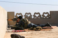 <p>A sniper from Iraq’s Federal Police force takes aim at Islamic State positions from the roof of a house on the frontline in Albu Saif, south of Mosul, Iraq, Feb. 21, 2017. (Alaa Al-Marjani/Reuters) </p>