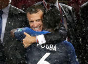 France President Emmanuel Macron embraces Paul Pogba during the presentations. REUTERS/Christian Hartmann