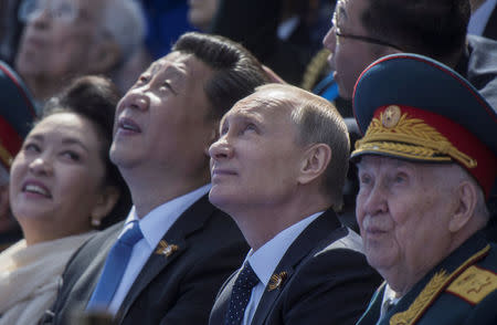 FILE PHOTO - Russia's President Vladimir Putin (2nd R) and China's President Xi Jinping (2nd L) watch the Victory Day parade at Red Square in Moscow, Russia, May 9, 2015. REUTERS/Host Photo Agency/RIA Novosti/File Photo