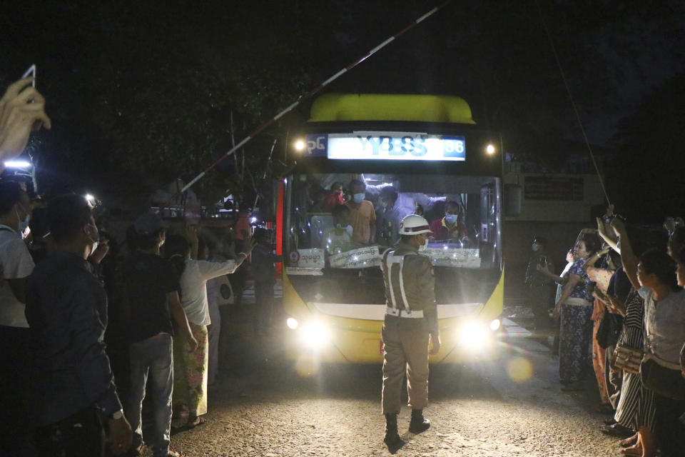 A bus with released prisoners onboard is driven out of Insein Prison in Yangon, Myanmar, Wednesday, June 30, 2021. Myanmar's government began releasing about 2,300 prisoners on Wednesday, including activists who were detained for protesting against the military's seizure of power in February and journalists who reported on the protests, officials said. (AP Photo)