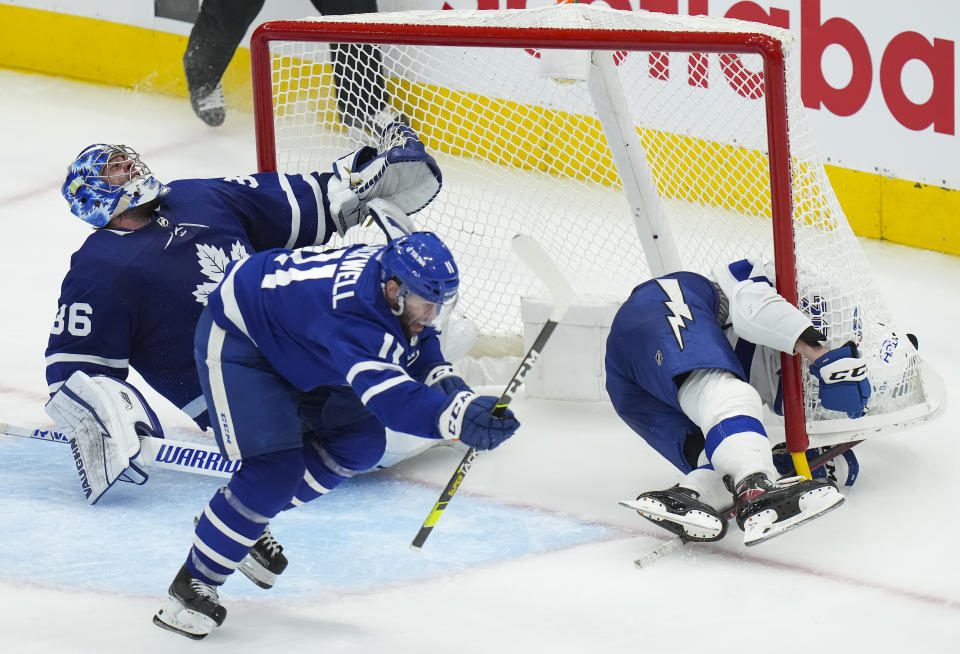 Tampa Bay Lightning forward Nicholas Paul (20) crashes into Toronto Maple Leafs goaltender Jack Campbell (36) as Maple Leafs forward Colin Blackwell (11) defends during the third period of Game 7 in an NHL hockey first-round playoff series in Toronto, Saturday, May 14, 2022. (Nathan Denette/The Canadian Press via AP)