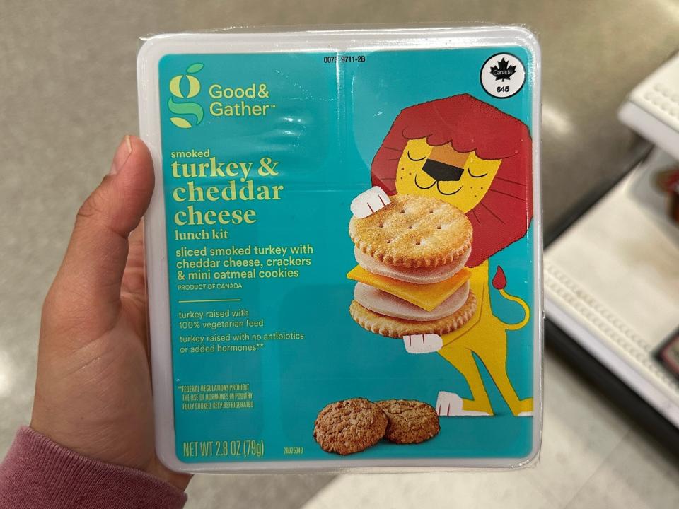 hand holding up a generic lunchable box at target