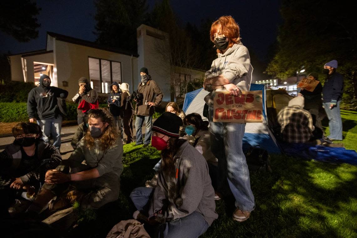 Cal Poly Humboldt students watch “Democracy Now” on a laptop last week to hear about pro-Palestinian student protests around the country. On Tuesday, police moved in to sweep the campus, arresting 25 people.