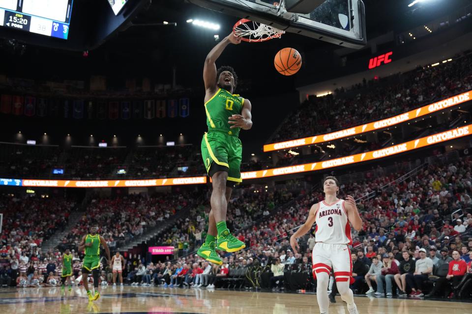 Mar 15, 2024; Las Vegas, NV, USA; Oregon Ducks guard Kario Oquendo (0) dunks the ball as Arizona Wildcats guard Pelle Larsson (3) watches in the second half at T-Mobile Arena. Mandatory Credit: Kirby Lee-USA TODAY Sports