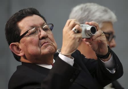 Salvadoran Ambassador to the Holy See Manuel Roberto Lopez Barrera takes a picture during a news conference on the beatification of slain Salvadoran Archbishop Oscar Romero at the Vatican February 4, 2015. REUTERS/Alessandro Bianchi
