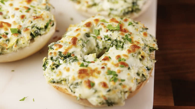 Spinach artichoke dip on bagel