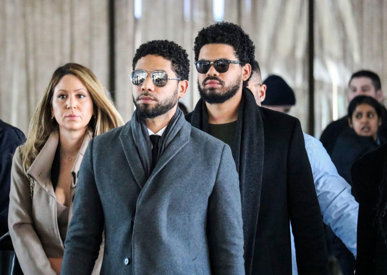 Jussie Smollett (C) and his team arrive for a court hearing at the Leighton Criminal Courthouse on March 12, 2019, in Chicago. A Chicago grand jury on March 8, 2019, indicted Jussie Smollett on 16 felony counts after allegedly lying to police about being the victim of a racist, homophobic hate crime. Police say Smollett -- who gained fame on Fox musical drama "Empire" -- staged the attack in a bid to gain publicity and a bigger paycheck.