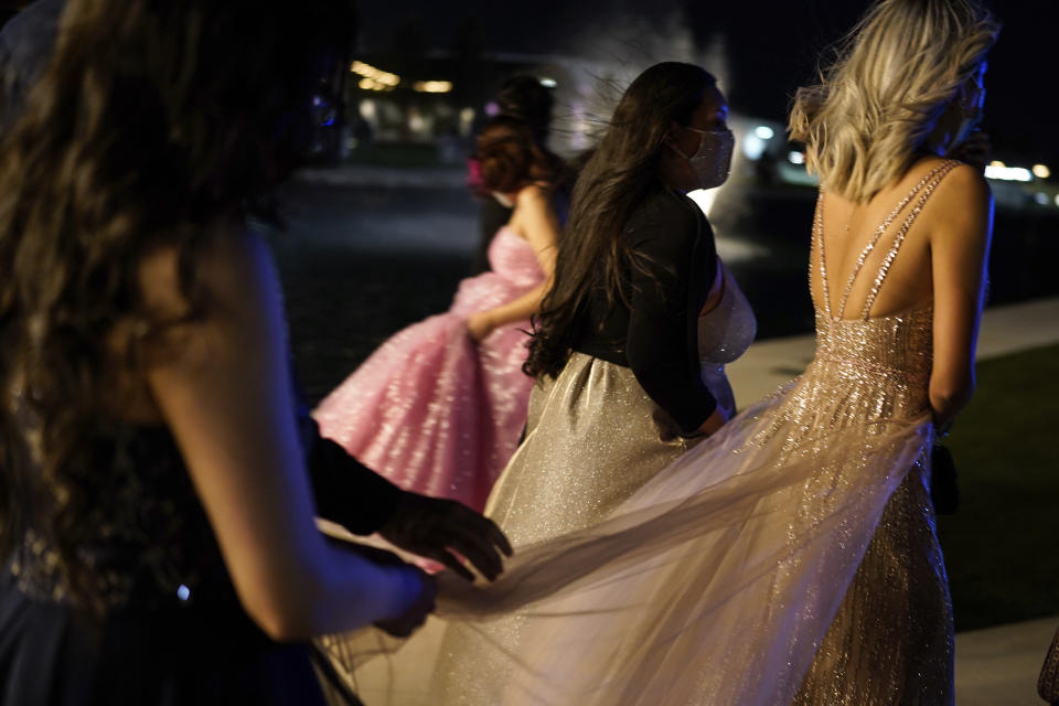 Young people attend prom at the Grace Gardens Event Center in El Paso, Texas on Friday, May 7, 2021. Around 2,000 attended the outdoor event at the private venue after local school districts announced they would not host proms this year. Tickets cost $45. (AP Photo/Paul Ratje)