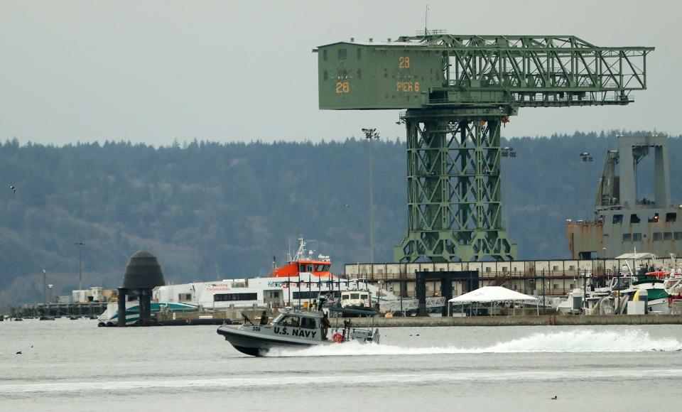 A US Navy security boats speeds by the Bremerton Marina as it escorts a submarine to Naval Base Kitsap-Bremerton on Monday.