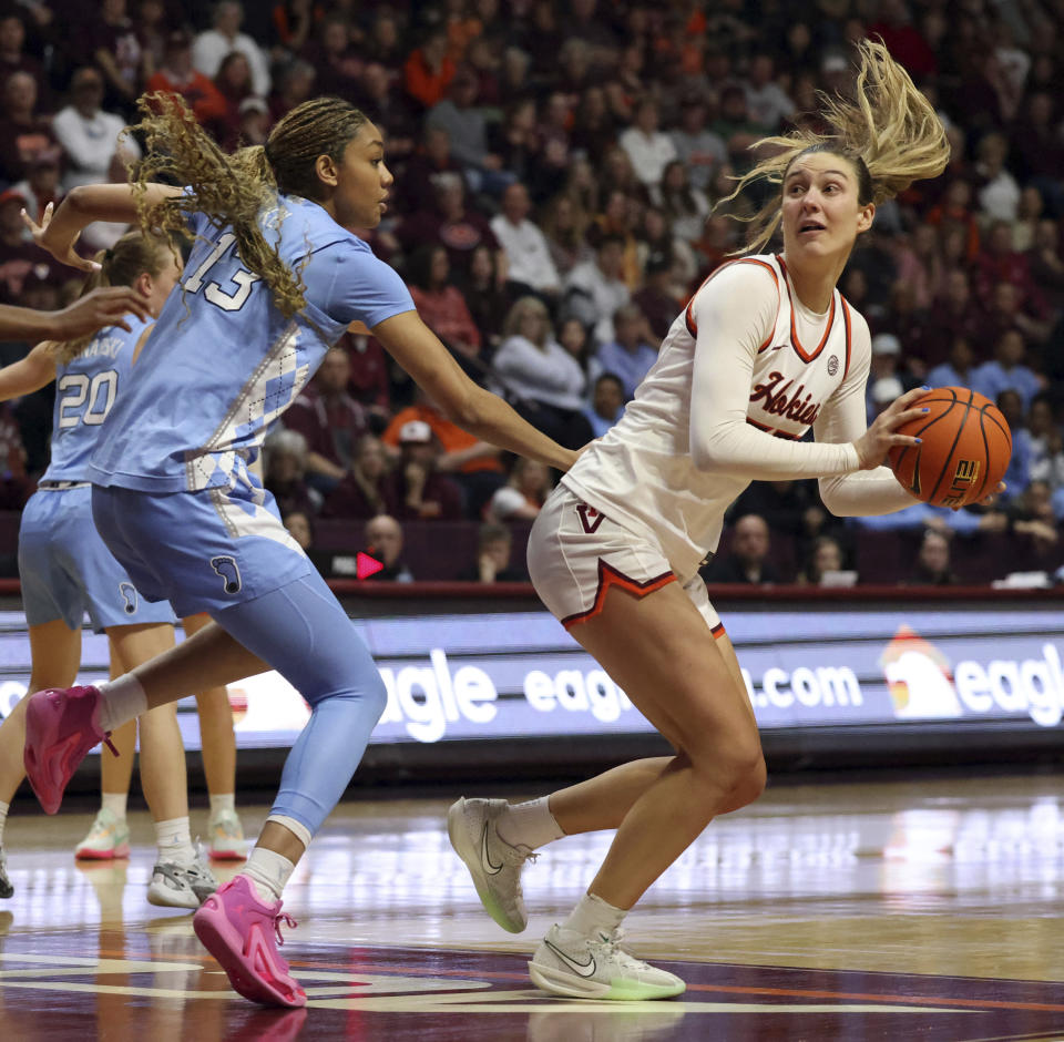 Virginia Tech's Elizabeth Kitley (33) turns to shoot while defended by North Carolina's Teonni Key (13) during the second half of an NCAA college basketball game in Blacksburg Va. Sunday, Feb. 25, 2024. (Matt Gentry/The Roanoke Times via AP)