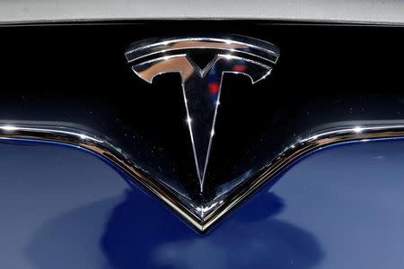 A Tesla logo is seen on media day at the Paris auto show, in Paris, France, September 30, 2016. REUTERS/Benoit Tessier/File Photo
