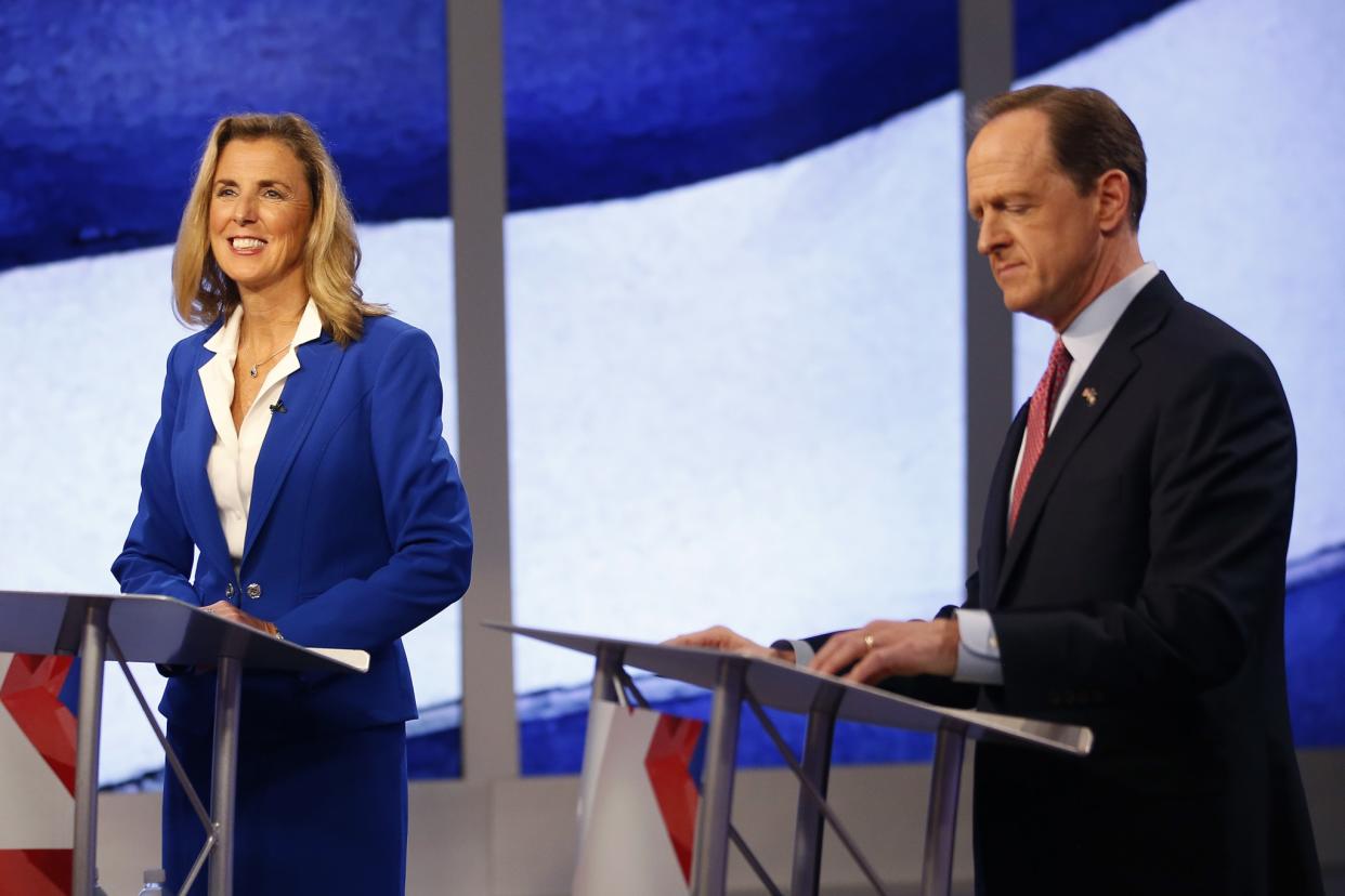 Senate candidates Katie McGinty, a Democrat, and incumbent Republican Sen. Pat Toomey prepare for their debate in Pittsburgh Oct. 17. (Photo: Jared Wickerham/AP)