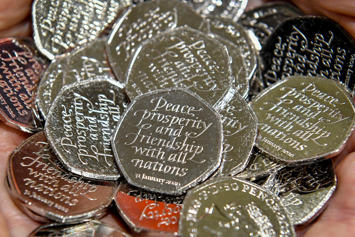 Coins are checked from storage bins after pressing at the Royal Mint in Llantrisant, Pontyclun, Wales, during production of the new 50p Brexit coin. Photo: Press Association