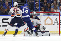 Edmonton Oilers goaltender Mike Smith makes a save against Tampa Bay Lightning's Pat Maroon as Darnell Nurse defends during the first period of an NHL hockey game Thursday, Feb. 13, 2020, in Tampa, Fla. (AP Photo/Mike Carlson)
