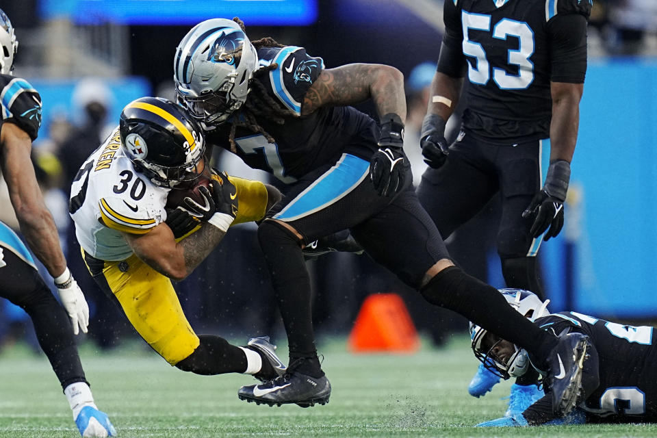 Pittsburgh Steelers running back Jaylen Warren is tackled by Carolina Panthers linebacker Shaq Thompson during the second half of an NFL football game between the Carolina Panthers and the Pittsburgh Steelers on Sunday, Dec. 18, 2022, in Charlotte, N.C. (AP Photo/Rusty Jones)