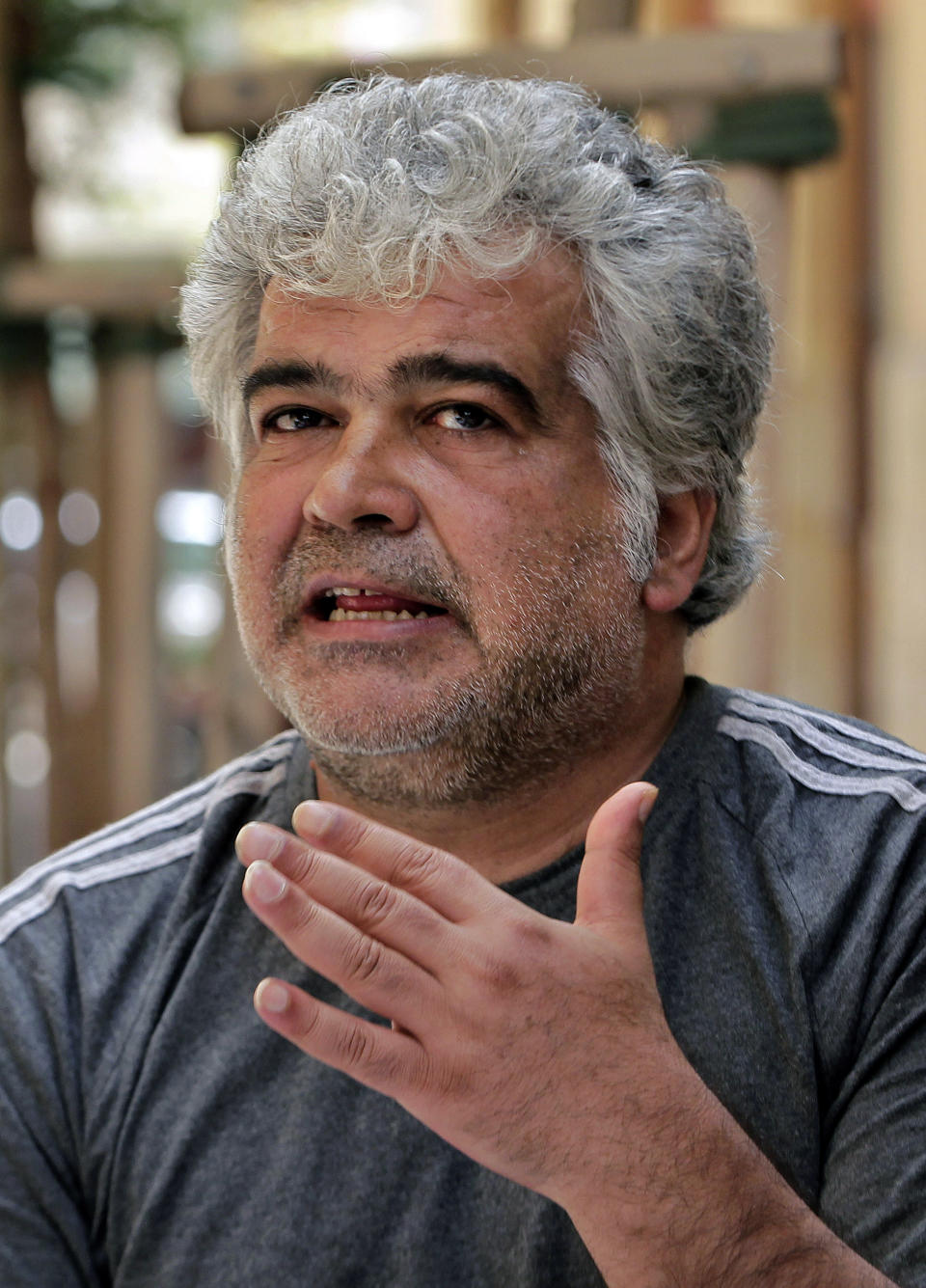 In this Monday, April 21, 2014 photo, Syrian novelist Khaled Khalifa, speaks during an interview with The Associated Press at a cafe in downtown Beirut, Lebanon. Khalifa’s thoughts keep wandering back to his home and favorite place in the world, the northern city of Aleppo, Syria. For him, the ancient metropolis of Aleppo is much more than a beautiful city known for its majestic, 13th century citadel, spicy cuisine and maze-like covered bazaar. It is his inspiration, the center of his pain, the place where the seeds of rebellion against an oppressive government were formed. (AP Photo/Bilal Hussein)