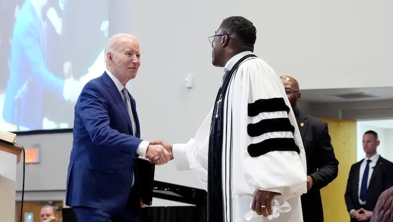 The Rev. Dr. Jamey O. Graham Sr., right, greets President Joe Biden before Biden speaks at St. John Baptist Church in Columbia, S.C., on Sunday, Jan. 28, 2024.