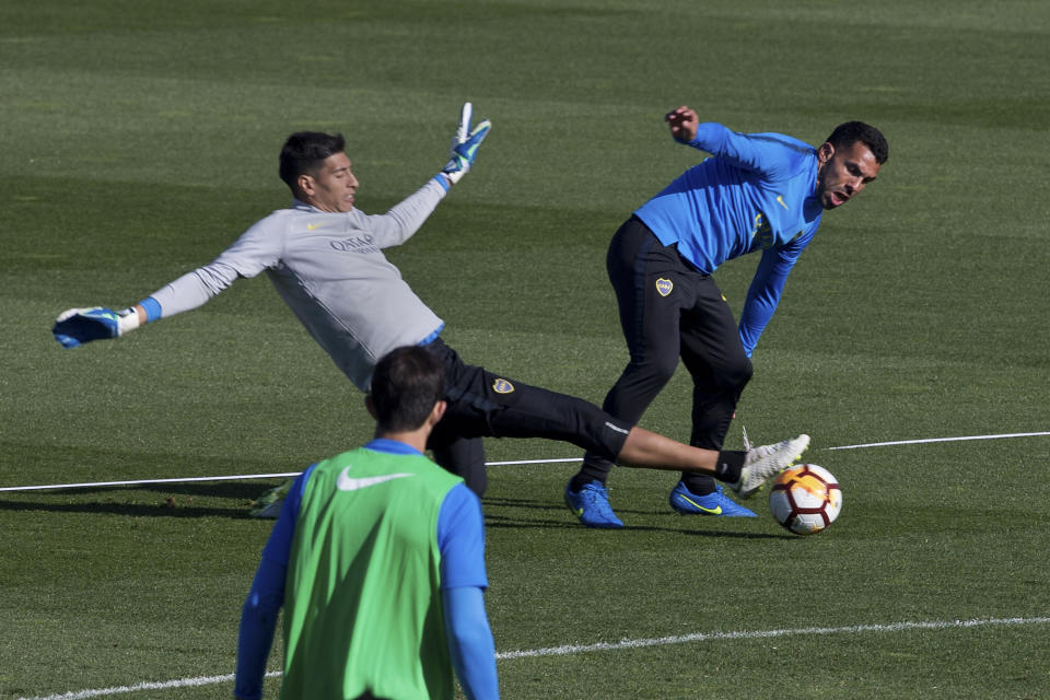 Boca Junior's Carlos Tevez, right, is challenged by goalkeeper Esteban Andrade during a training session in Madrid, Spain, Thursday, Dec. 6, 2018. The Copa Libertadores Final will be played on Dec. 9 in Spain at Real Madrid's stadium for security reasons after River Plate fans attacked the Boca Junior team bus heading into the Buenos Aires stadium for the meeting of Argentina's fiercest soccer rivals last Saturday. (AP Photo/Paul White)