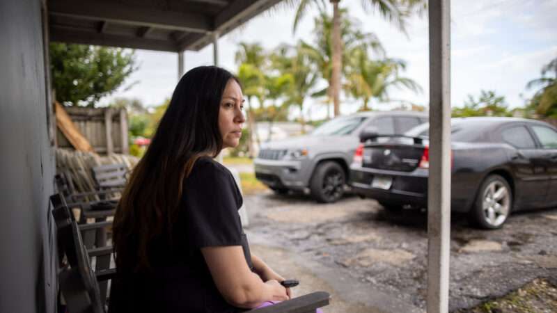 Sandy Martinez sits on a porch