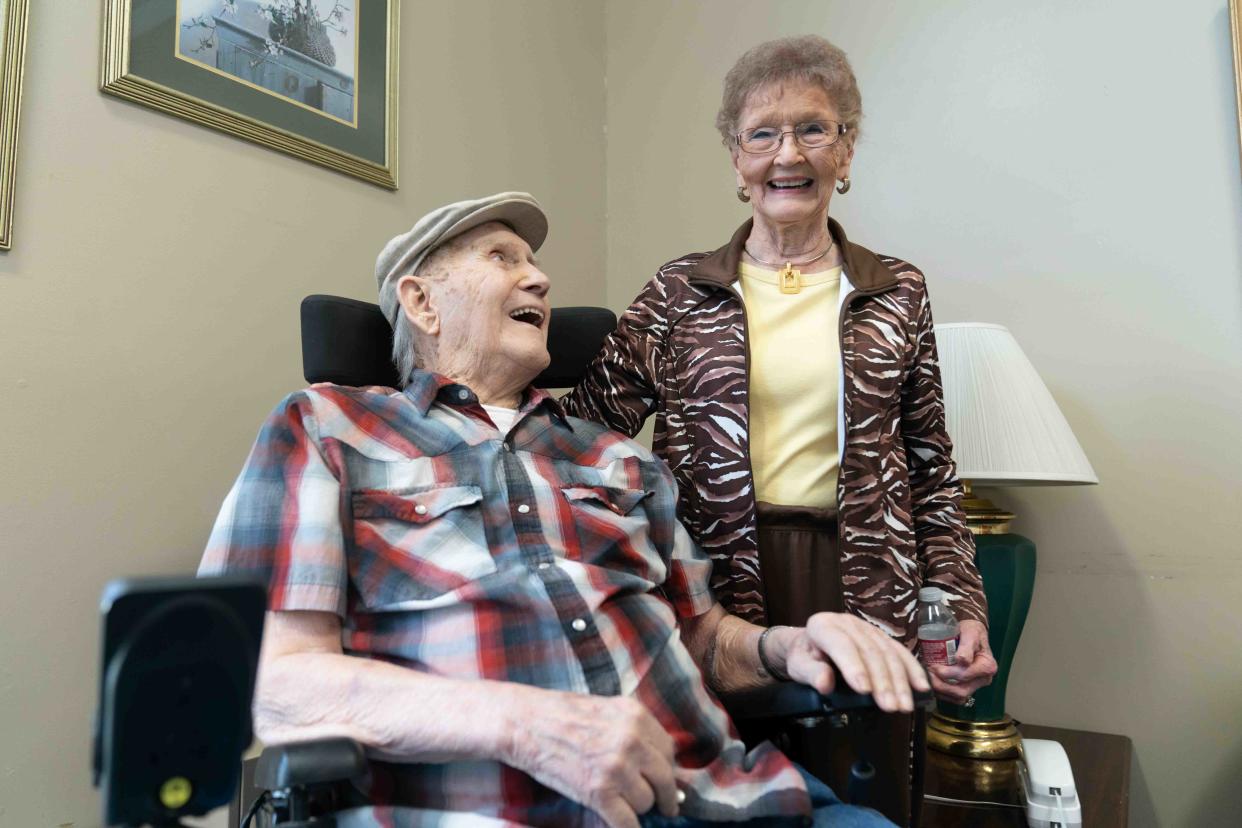 Ken Cowan looks up toward Bethe, his wife of 73 years, on Tuesday at Plaza West Care Center, 1570 S.W. Westport Drive.