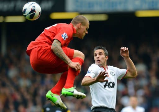 Liverpool's Slovakian defender Martin Skrtel (L) vies with Manchester United's Dutch striker Robin van Persie during the English Premier League football match between Liverpool and Manchester United at Anfield in Liverpool. Ten-man Liverpool were left searching for their first Premier League win under new manager Brendan Rodgers as arch-rivals Manchester United came from behind to win 2-1