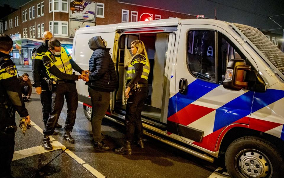 Dutch police arrest lockdown protesters in Rotterdam amid nationwide riots against the government - Shutterstock 