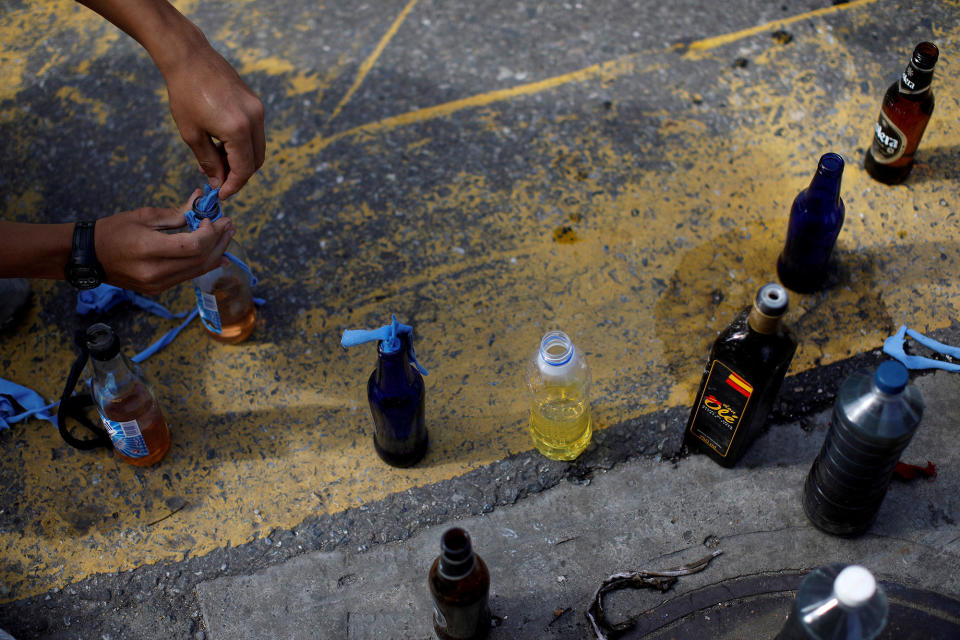 <p>A demonstrator prepares petrol bombs during a strike called to protest against Venezuelan President Nicolas Maduro’s government in Caracas, Venezuela, July 26, 2017. (Photo: Carlos Garcia Rawlins/Reuters) </p>