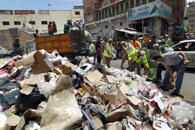 Yemeni volunteers in Sanaa on May 4, 2015 collect rubbish from the city's streets, where garbage trucks are hardly running due to shortage of fuel
