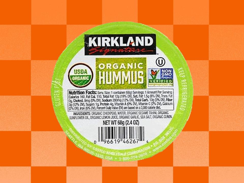 Kirkland Signature Organic Hummus dip on an orange checkered background