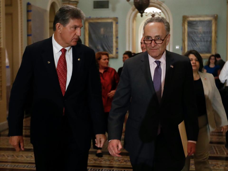 Democratic Sen. Joe Manchin of West Virginia (left) and Senate Majority Leader Chuck Schumer of New York have arrived at a surprise inflation deal that the Senate will start considering on August 6.